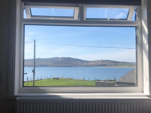 a window with a view of a body of water at Cala Sith Guesthouse in Port Ellen