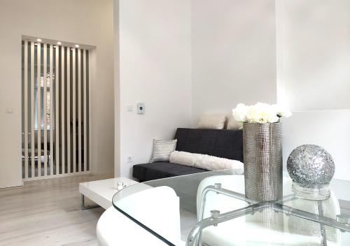 a living room with a couch and a glass table at Luxurios and historic apartment "Shine" - right on the Main Square in Zagreb