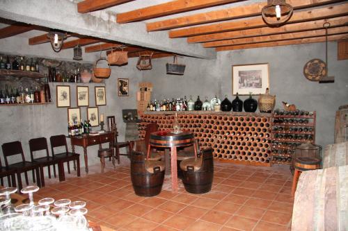 a bar with a table and some bottles of wine at Refúgio das Camélias in Santana
