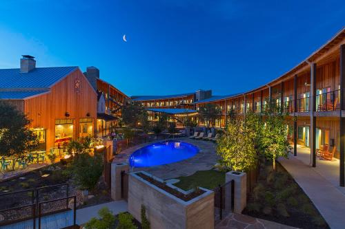 an indoor courtyard with a swimming pool in a building at Lone Star Court, by Valencia Hotel Collection in Austin