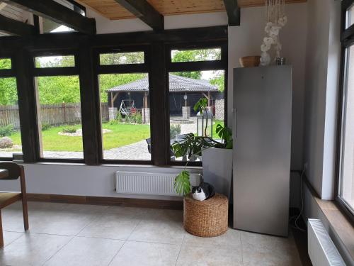 a living room with a large window with a plant at Casa Pisica Noastra in Breaza