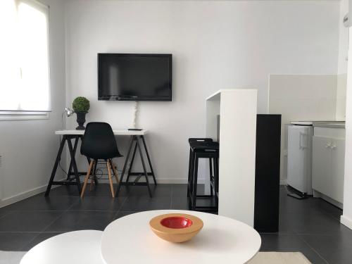 a living room with a tv on a wall at Nice Promenade 1 in Nice