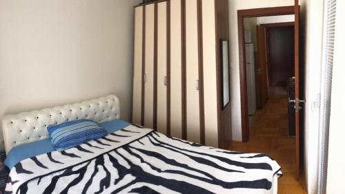 a bedroom with a bed with a zebra print blanket at Relax in Budva