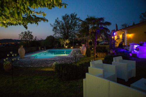 a swimming pool in a yard at night at VILLA "Casa al Chiazzullo" in Mirabella Eclano