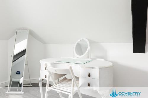 a white dressing table with a mirror and a chair at 2 Bedroom Apartment, NEC, HS2, BHX, JLR - Devereux House, Hosted By Coventry Accommodation in Coleshill