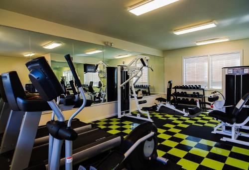 a gym with treadmills and machines in a room at Lone Star Court, by Valencia Hotel Collection in Austin