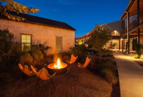 a fire pit in a yard next to a building at Lone Star Court, by Valencia Hotel Collection in Austin