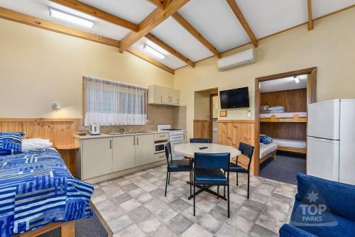 a kitchen with a table and chairs in a room at Millicent Hillview Caravan Park in Millicent
