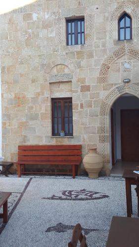 a building with a bench in front of a building at Lindos Center Studios in Lindos