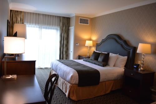 a hotel room with a bed and a window at Majestic Inn and Spa in Anacortes