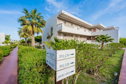 a house with a sign in front of it at Lardos Bay Hotel in Lardos