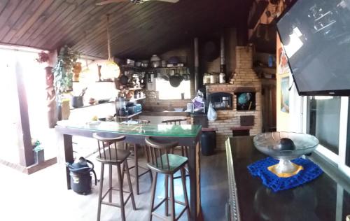 a kitchen with a counter and stools in a room at Airport Pousada in Cabo Frio