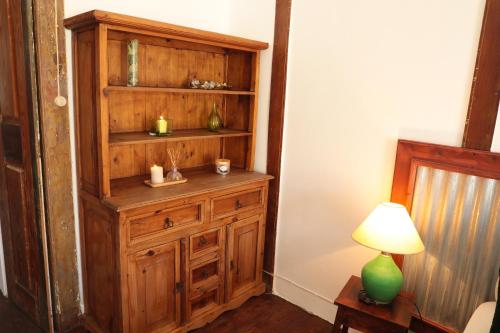 a room with a wooden hutch and a lamp at Casa Colonial Koenig in São Filipe