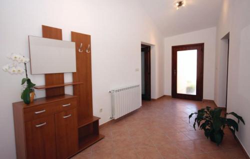 a living room with a tv on a wooden dresser at Holiday home Elis in Fažana