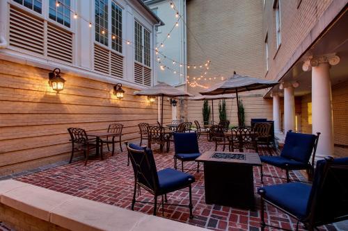 an outdoor patio with tables and chairs and umbrellas at The Inn at Wise in Wise
