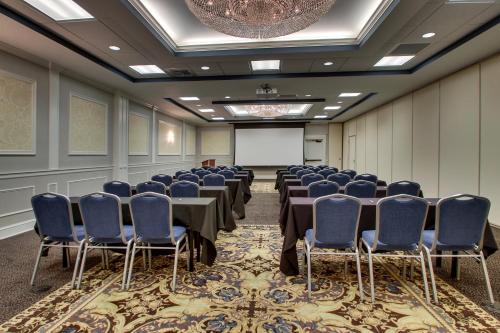 a conference room with a table and chairs and a screen at The Inn at Wise in Wise