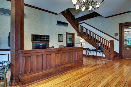 a large living room with a wood paneling and stairs at The Inn at Wise in Wise