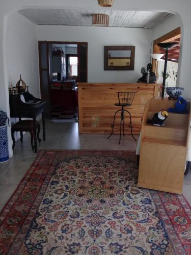 a living room with a couch and a table at Pouso do Rio in Pirenópolis