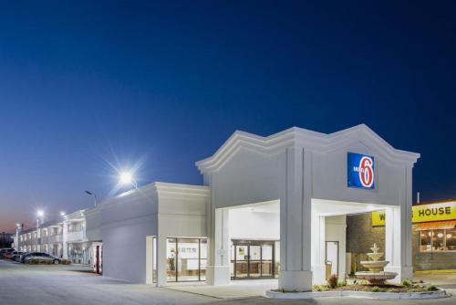 a large white building with a number sign on it at Motel 6-Jacksonville, NC in Jacksonville