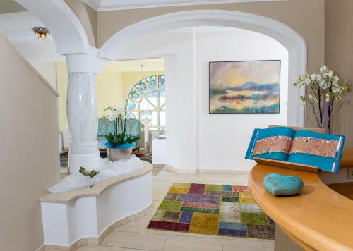 a living room with a table with books on it at Villa Christina in Pörtschach am Wörthersee