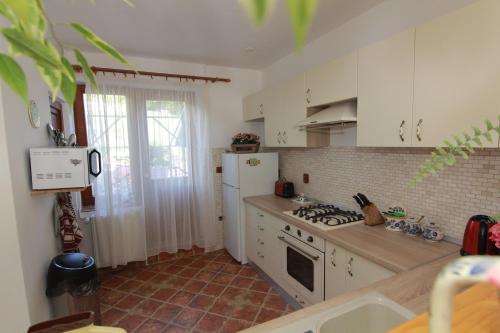 a kitchen with white cabinets and a stove top oven at Raza Soarelui in Sovata