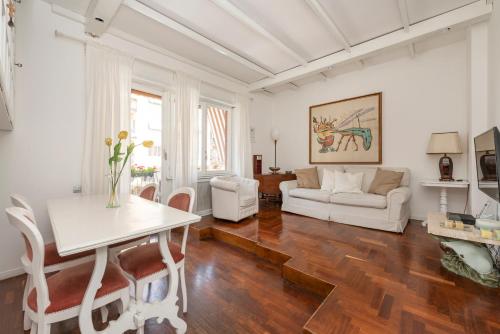 a living room with a table and a couch at Shabby Chic Flat Monte Mario in Rome