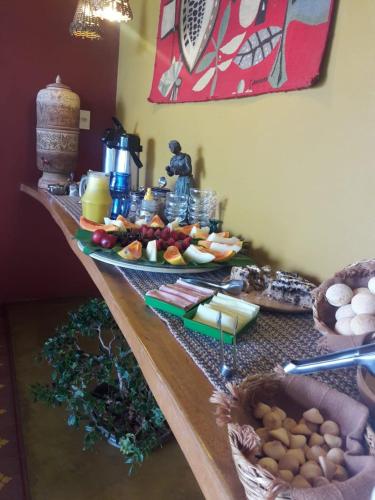 a table with plates of food on top of it at Pousada Encantos do Cerrado in Delfinópolis