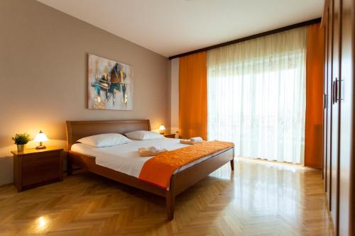 a bedroom with a bed and a large window at Apartment Meri in Krk