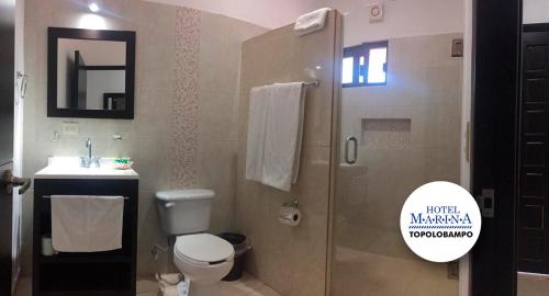 a bathroom with a shower and a toilet and a sink at Hotel Marina Topolobampo in Topolobampo