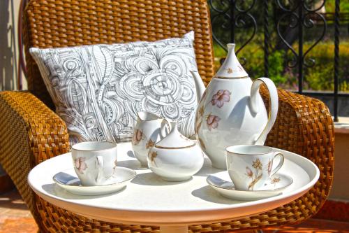 a table with tea cups and vases on it at Agape in Kala Nera