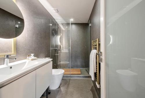 a bathroom with a toilet and a sink and a shower at Wake Up Famalicão in Vila Nova de Famalicão