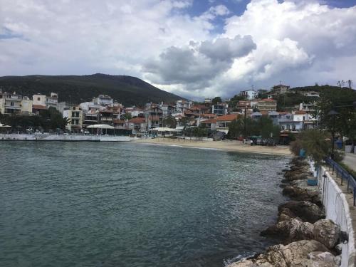 a view of a beach with a town in the background at SUNNY STUDIO in Skala Marion