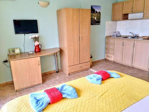 a kitchen with two towels on a large bed at Guest House Maria in Nesebar