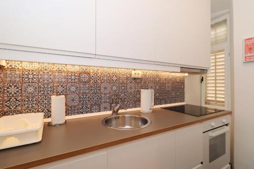 a kitchen with a sink and a counter top at Cicibela Apartment - Zadar in Zadar