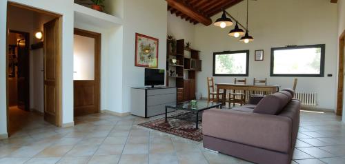 a living room with a couch and a table at Torrebianca Tuscany in Rignano sullʼArno