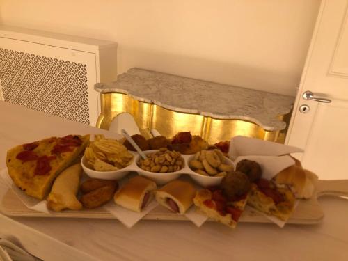 a platter of food on a counter with sandwiches and dips at Christian's Suites & Spa in Fasano