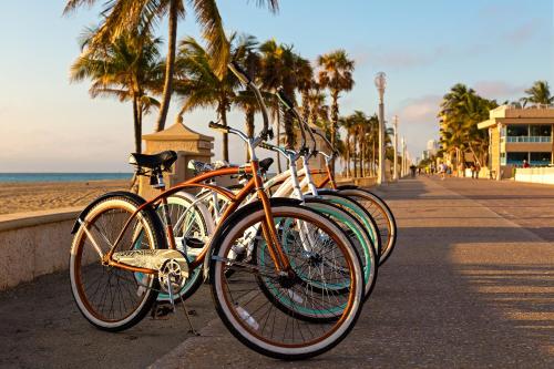 una fila de bicicletas estacionadas junto a la playa en Riptide Oceanfront Hotel, en Hollywood