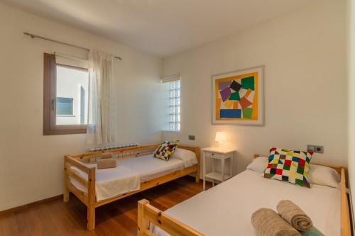 a bedroom with two beds and a window at Portocolom - 2618-36 Mallorca in Portocolom