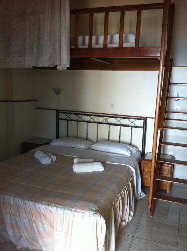 a bedroom with a bunk bed with two towels on it at Alkyonis Apartments in Panormos Kalymnos
