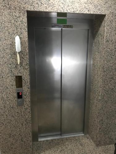 an elevator in a building with a phone on the wall at Senturkler Suite in Trabzon