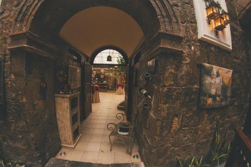 a hallway of a building with a stone wall at Roka Plaza Hotel Boutique in Ambato