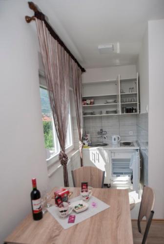 a kitchen with a table and a kitchen with a stove at Guesthouse Buco in Trebinje