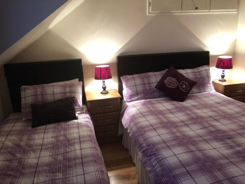 two beds sitting next to each other in a bedroom at Ocean view B&B X35X250 in Ringville