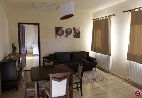 a living room with a couch and a table at Rábagyarmati Apartman II in Rábagyarmat