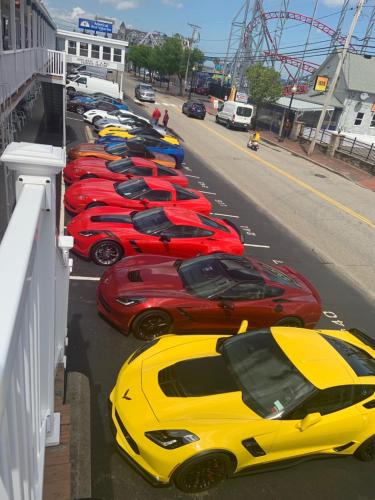 a row of expensive cars parked on a street at Mt Royal Motel in Old Orchard Beach