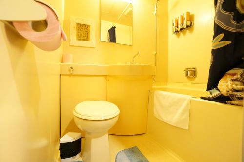 - une petite salle de bains jaune avec toilettes et lavabo dans l'établissement Takayama - Apartment / Vacation STAY 34382, à Takayama