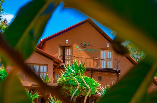 a building with a sign on the side of it at Hotel Rancho Constanza & Cabañas de la Montaña in Constanza