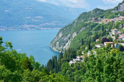a view of a town on a hill with a body of water at Hotel Diffuso Il Portichetto sulla collina a Vezio Perledo in Perledo