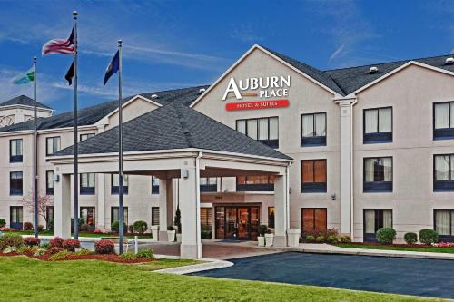 an exterior view of a hotel with two flags at Auburn Place Hotel & Suites Paducah in Paducah