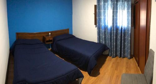 Ένα ή περισσότερα κρεβάτια σε δωμάτιο στο Hostal El Arco